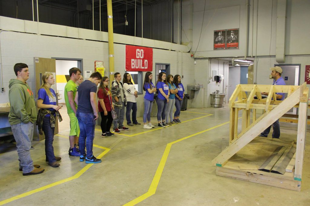 AGC of America is working on introducing more young people to construction as a viable, fulfilling career. Here, students in Georgia tour a construction company's warehouse while hearing from a company official about the work they do and the career opportunities they provide.