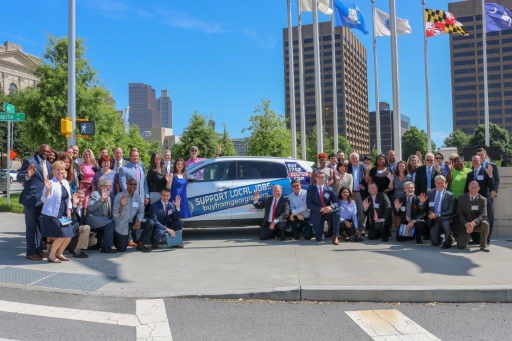 Members of Kia Manufacturing pause to enjoy Buy From Georgia Day at the Georgia State Capitol.