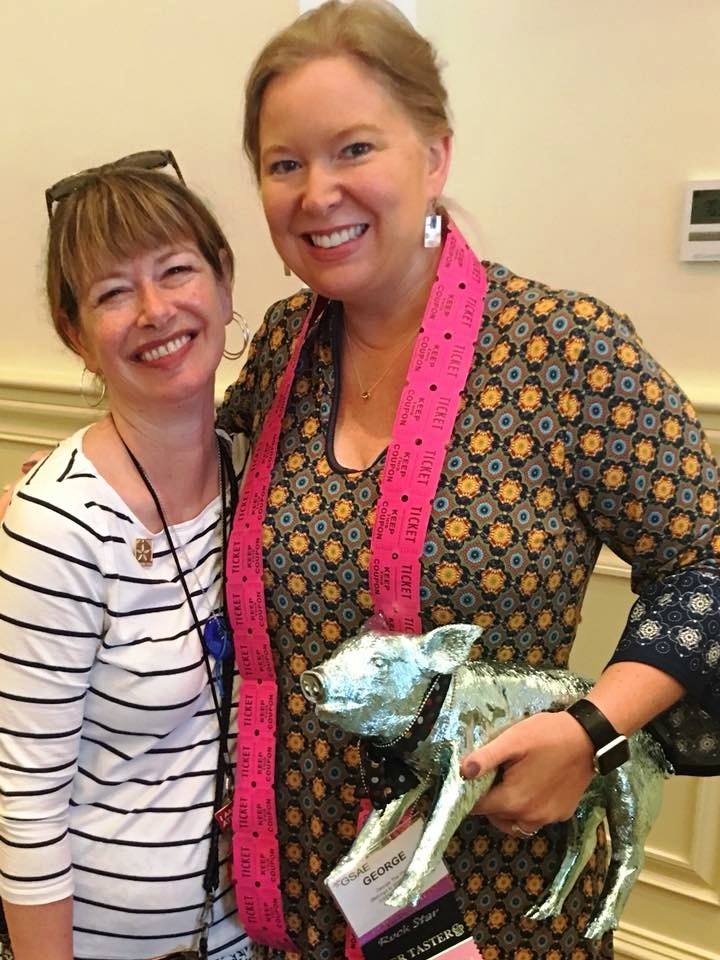Wendy Kavanagh, CAE and Lori Spear, CAE, with the decorative pig that sparked the idea for GSAE's popular fundraiser, "Pay the Pig."