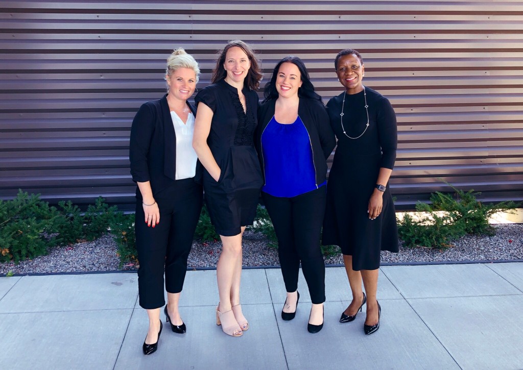 Four association professional women pose for a photo.