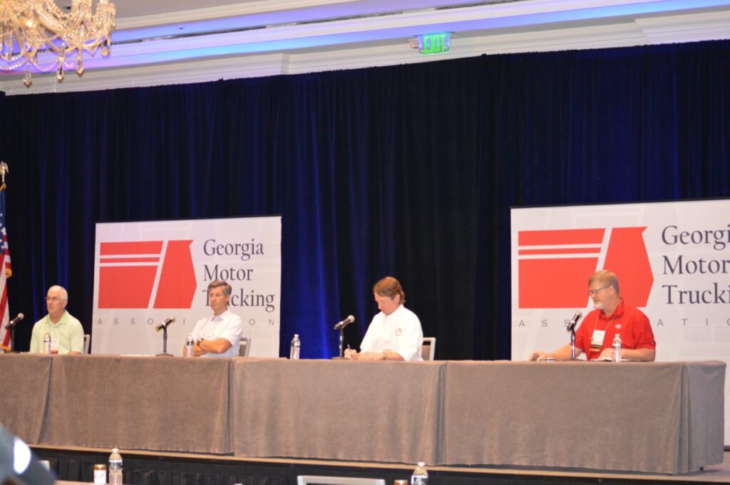 GMTA presenters speaking from the head table in a ballroom